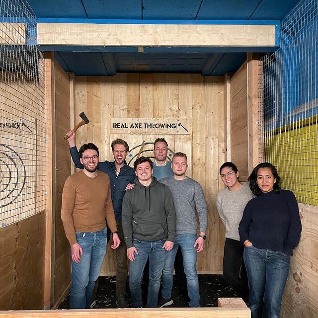 An image of our team having an axe throwing competition.