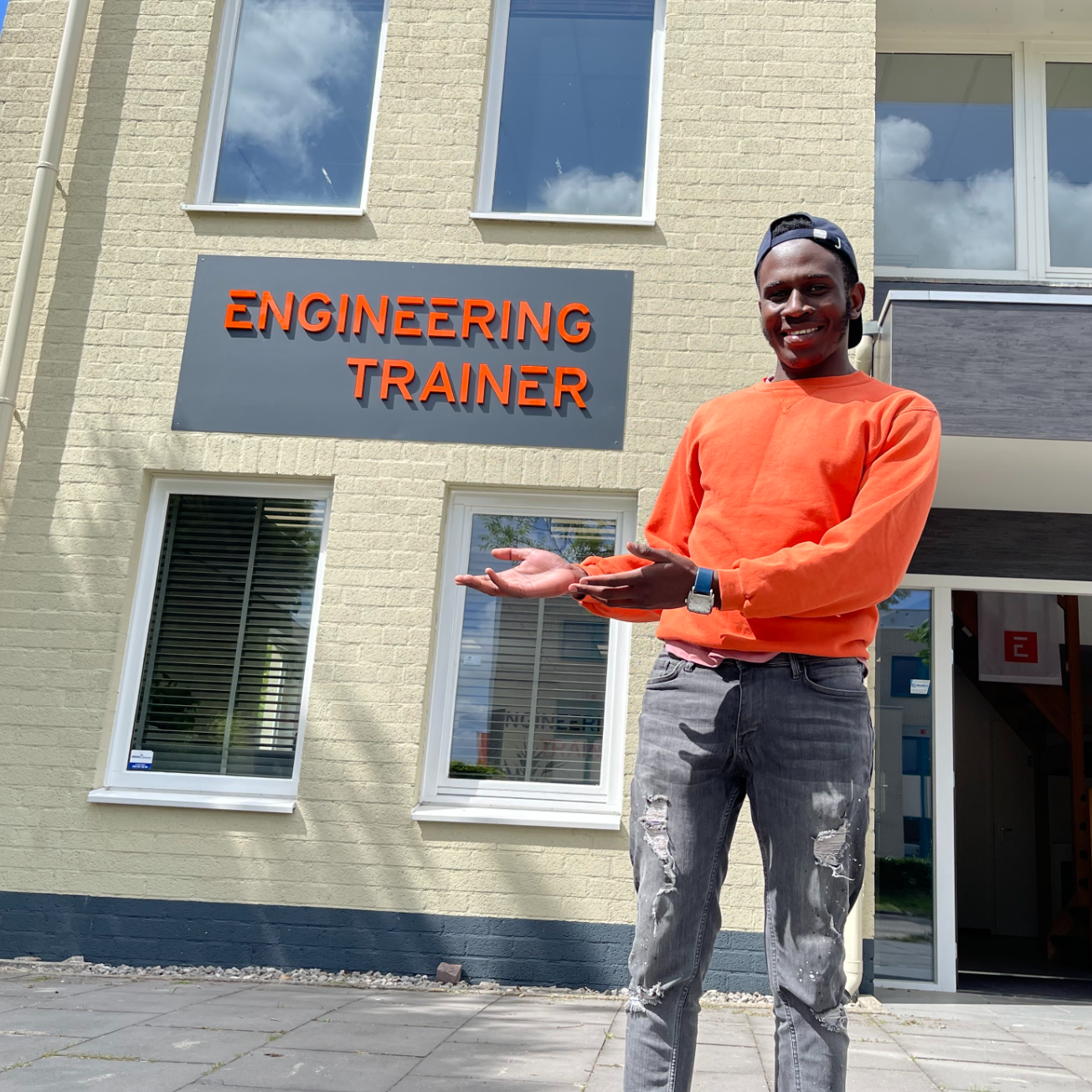 An image of Kevin showcasing the logo of EngineeringTrainer.